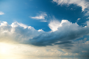 White clouds on the background of a dark stormy sky.