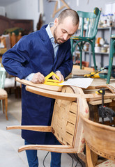 Craftsman looking at drawing in workshop