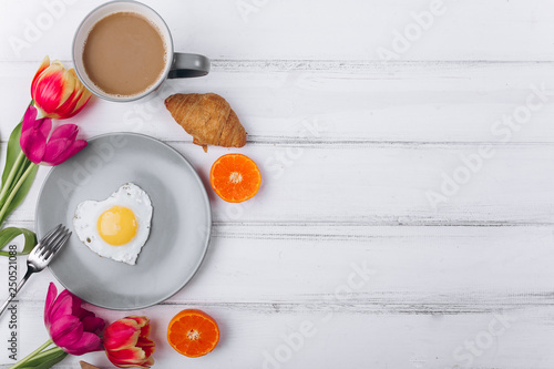 Mother's day composition.Breakfast with tulips on white background.