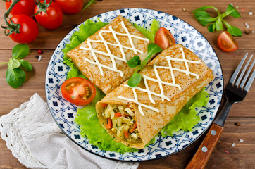 Crepes stuffed with stewed cabbage with carrots and eggs.
