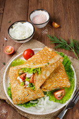 Crepes stuffed with Caesar salad, chicken, tomatoes, cheese and lettuce.