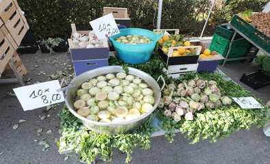 greengrocery  on the street with many artichokes and fruit for s