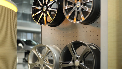 Car Wheel Rims On The Rack In Automobile Service Center  