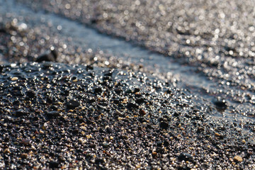 Textured surf and pebble at a beach of Gran Canaria island