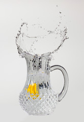 Crystal water pitcher splash with lemon