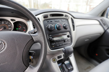 Automobile interior with steering wheel, gear shift and controls