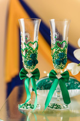 wedding glasses decorated with green cloth