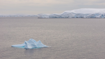 View of ice mountains and icebergs on bay in Antarctica