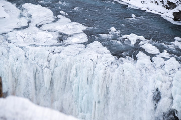 Icelandic Iceland waterfall frozen and covered in snow during winter