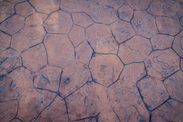 Vintage nature cobblestone and pebbles pavement in disorganized arrangement pattern background. Paving blocks made of nature asymmetrical stone background.