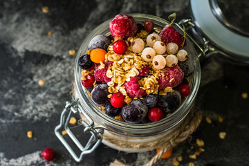 Yogurt with granola and berries in small jar, strawberries, blueberries., black currant. sweetness. Homemade yogurt. Healthy food. Healthy meal. Vegetarian. Vegan. Healthy breakfast. Honey granola.