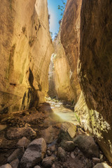 Amazing natural landscape in the Avakas canyon in Cyprus. National sunny wild park with cliffs, mountains, rocks and trees.