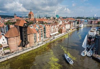 Obraz premium The bird view of Gdansk, old town and famous crane at amaizing old port with sailing boats. Poland
