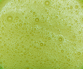 Green avocado milkshake with bubbles texture
