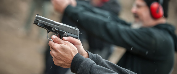 Group of civilian practice gun shooting on outdoor shooting range © guruXOX