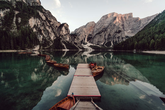 Rowboats moored in lake against mountains range