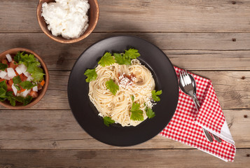 spaghetti dish over wooden table