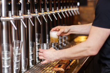 innkeeper draws a beer at a beer pump