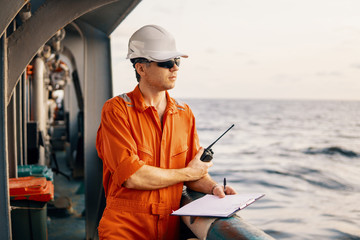 Marine Deck Officer or Chief mate on deck of offshore vessel or ship , wearing PPE personal...