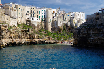 POLIGNANO A MARE, ITALY - MARCH 29th, 2018: Suggestive landscape view on dramatic cliffs with caves rising from Adriatic sea in Polignano a Mare, Puglia, Italy.