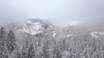 Aerial view of snow covered Sierra Nevada Mountains in California during record snowfall season.