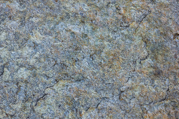 Granite texture close up. Granite rocks with porous surface. Background from solid stone. Pattern with natural material
