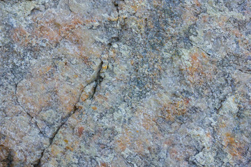 Granite texture close up. Granite rocks with porous surface. Background from solid stone. Pattern with natural material