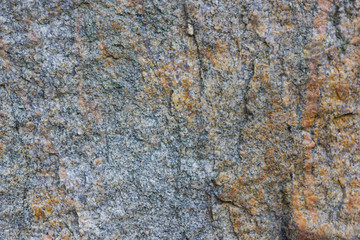 Granite texture close up. Granite rocks with porous surface. Background from solid stone. Pattern with natural material