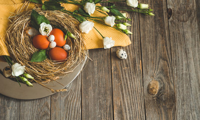 Happy Easter background. Easter eggs in a nest on a metal plate on a wooden background. Happy Easter concept