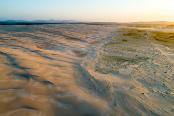 Aerial view of sand dunes near the ocean at sunset. Anna Bay, New South Wales, Australia