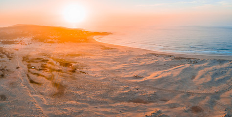 Aerial panorama of sunrise over ocean coastline with copy space