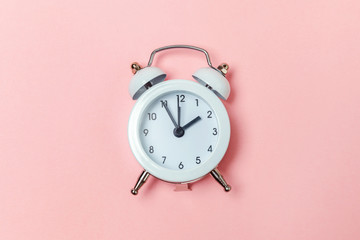 Ringing twin bell vintage classic alarm clock Isolated on pink pastel colorful trendy background....