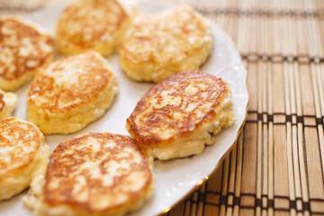 Close up cheese pancakes, cheese cakes, cottage cheese pancakes on a white plate background.