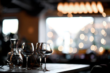 Blurred background in restaurant interior  details in blurred bokeh focus on empty wine glasses