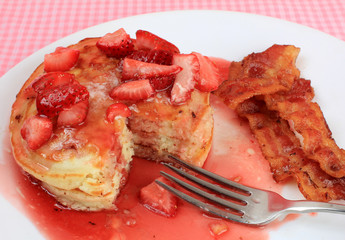 Eating Strawberry Pancakes and Bacon Breakfast