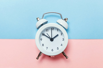 Ringing twin bell vintage classic alarm clock Isolated on blue pink pastel colorful trendy...