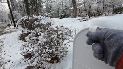fetching the mail in winter after the snow fall