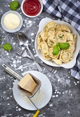 fresh tortellini in a bowl with basil and parmesan