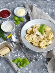 fresh tortellini in a bowl with basil and parmesan