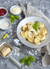 fresh tortellini in a bowl with basil and parmesan