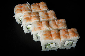philadelphia roll sushi with cucumber, cream cheese and tiger shrimp on top