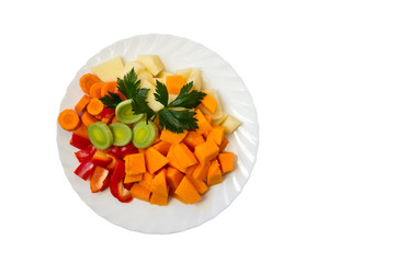 Fresh vegetables on a plate, on a white background.