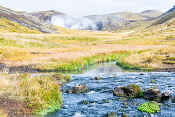Hveragerdi Hot Springs river creek in Reykjadalur morning day in south Iceland golden circle with steam vent fumarole landscape and vapor mist