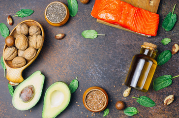 Fototapeta na wymiar Animal and vegetable sources of omega-3 acids as salmon, avocado, linseed, oil, nuts, chia seeds, spinach.