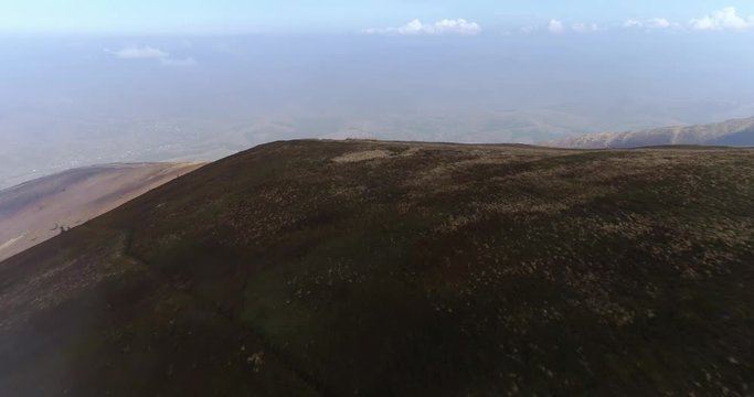 Aerial view: Flying over an amazing mountain near the peak of Gemba. 4k