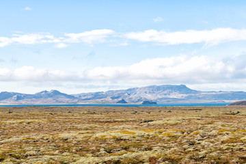 Landscape view of Laugarvatn mountains and lake distant with clouds on golden circle in Iceland during day and blue color sky in autumn