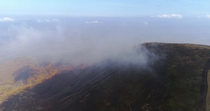 Aerial view: Flying over an amazing mountain near the peak of Gemba. 4k