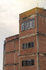Fototapeta na wymiar Corner building, old brick wall.