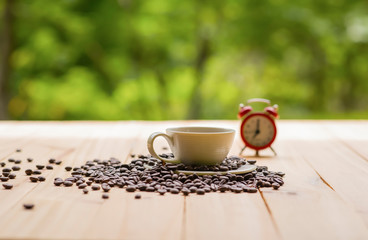 Cup of coffee white notebook, pencil, coffee beans on a Desktop from wooden plank.
