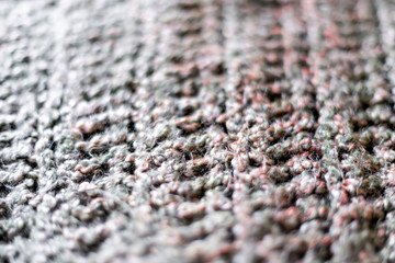 Macro abstract closeup texture of yarn knitted sweater or scarf handmade with pink and grey colors background